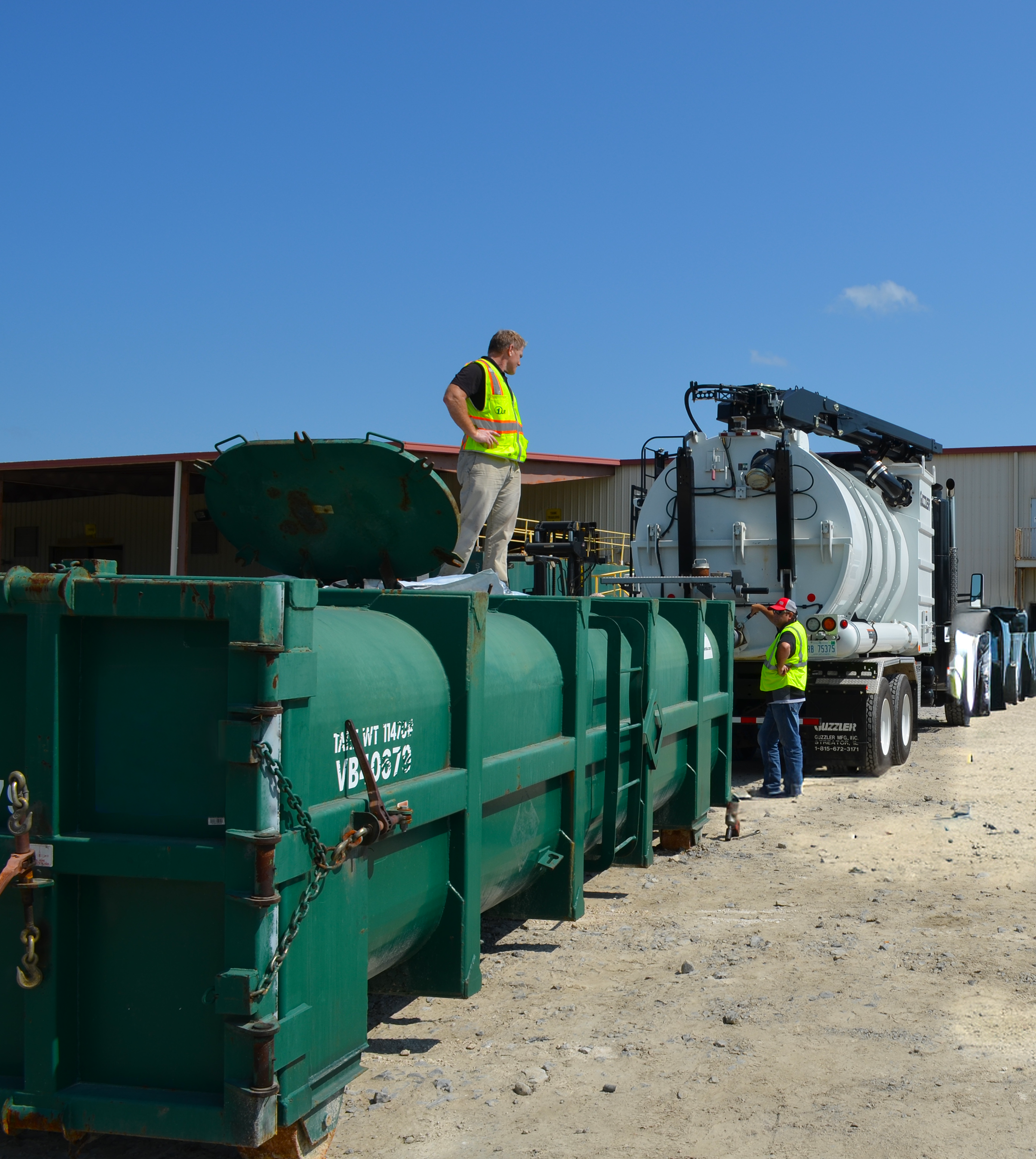 [I] VacPac- Troy Standing on a VacPac Hooked Up to Truck